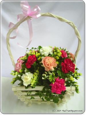 FlowersToSaigon.com: Mixed Carnation Basket - These gorgeous carnations are sure to bring a smile to anyone's face! This handle basket holds 12 assorted carnations with greens. A terrific gift for any occasion.