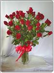 Express your feelings with this romantic bouquet. Three dozen long-stemmed red roses in a glass vase and trimmed with a red ribbon bow. 