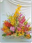 Mixed orchids arranged with other greens in a handle basket. Approximately 70cm Height